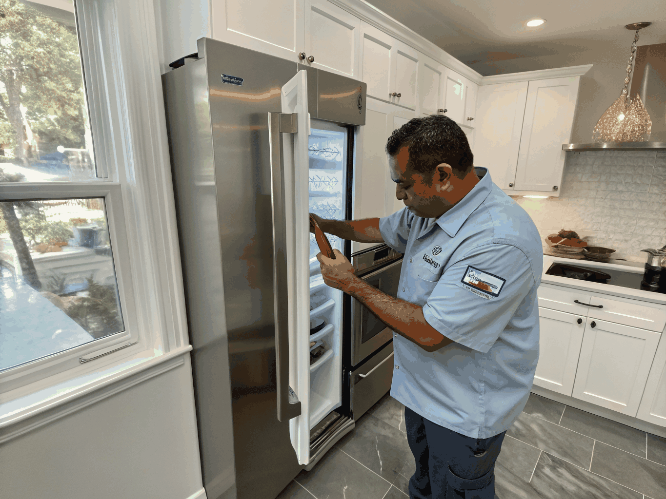 Upright freezer compartment being serviced by a certified technician